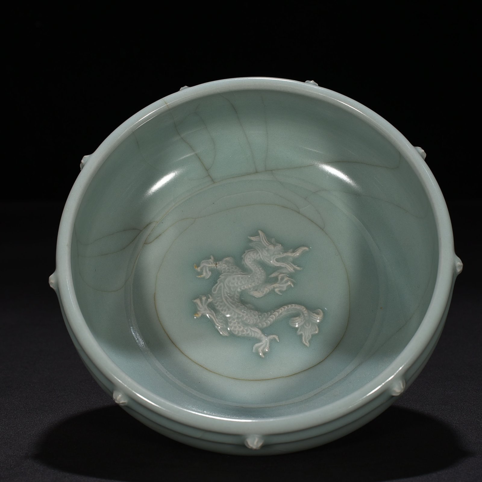 Song Dynasty Longquan kiln pink celadon glaze stacked dragon pattern drum nail wash