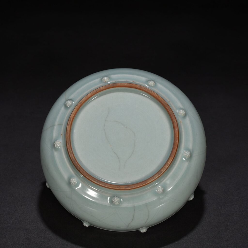 Song Dynasty Longquan kiln pink celadon glaze stacked dragon pattern drum nail wash