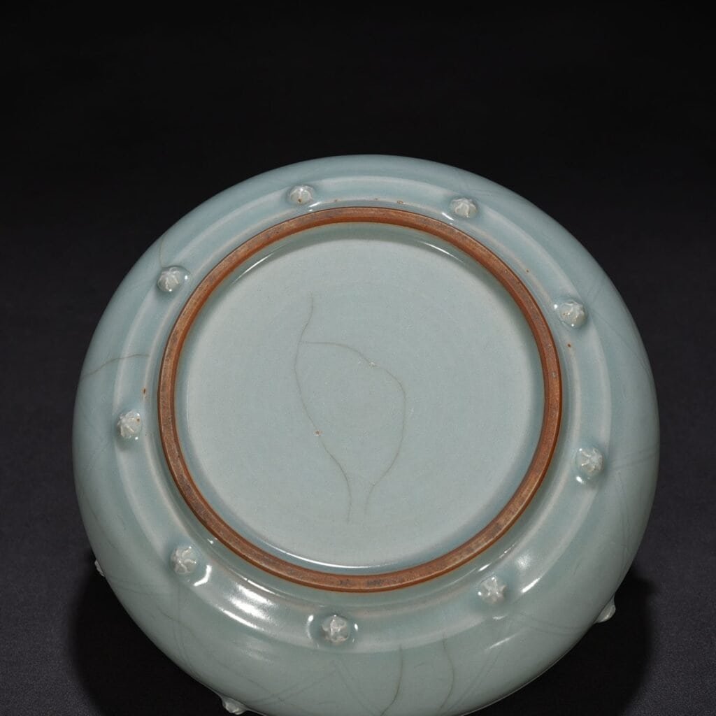 Song Dynasty Longquan kiln pink celadon glaze stacked dragon pattern drum nail wash