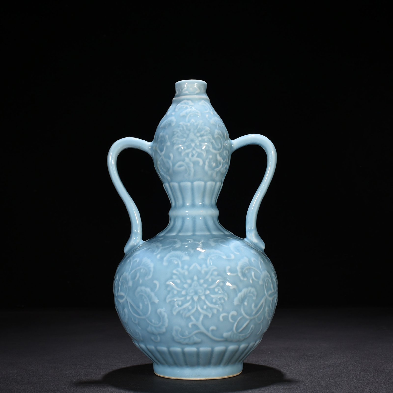 Qing Dynasty Qianlong sky blue glaze carved ruyi ear gourd vase with entwining floral pattern