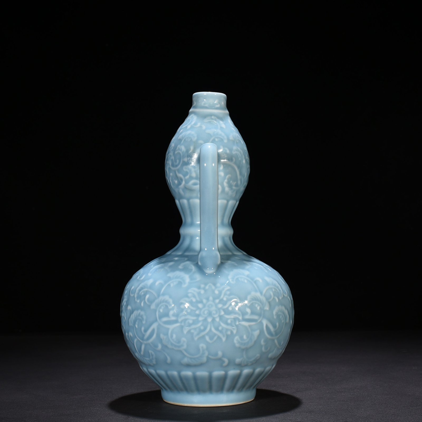 Qing Dynasty Qianlong sky blue glaze carved ruyi ear gourd vase with entwining floral pattern