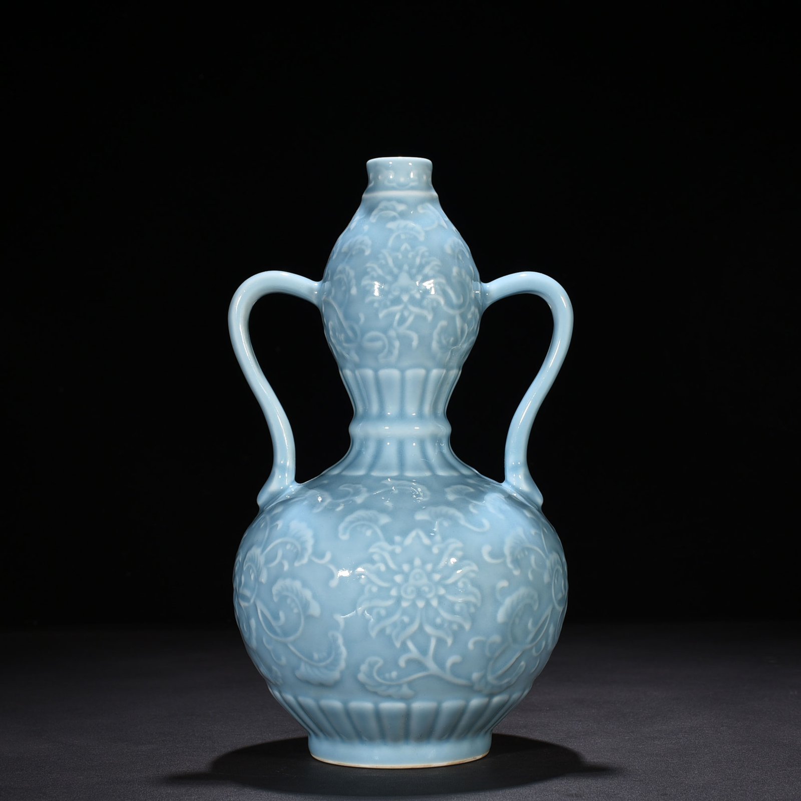 Qing Dynasty Qianlong sky blue glaze carved ruyi ear gourd vase with entwining floral pattern