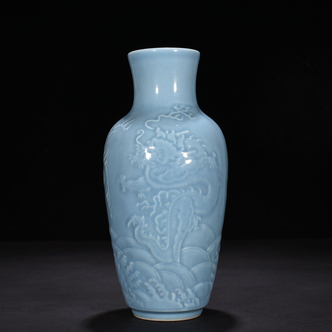 Qing Dynasty Qianlong sky blue glaze engraved dragon pattern vase