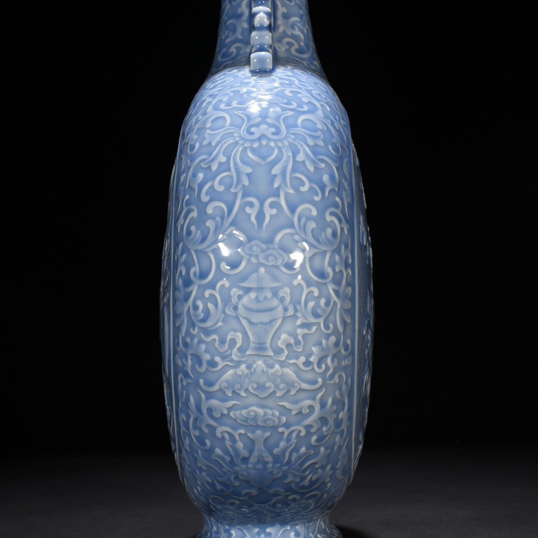Qing Dynasty Qianlong sky blue glaze carved blessing longevity and many children holding the moon vase