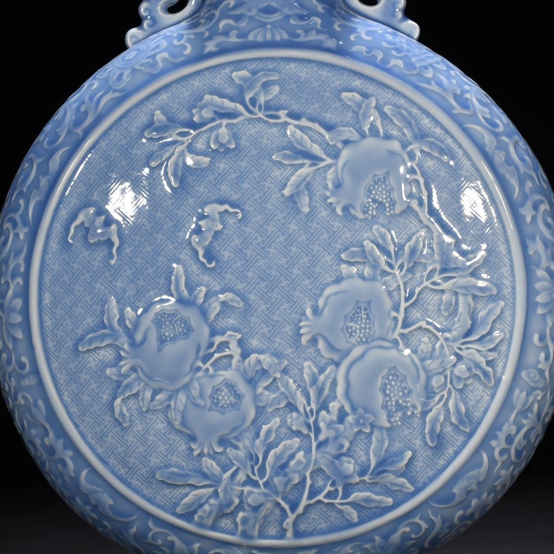 Qing Dynasty Qianlong sky blue glaze carved blessing longevity and many children holding the moon vase