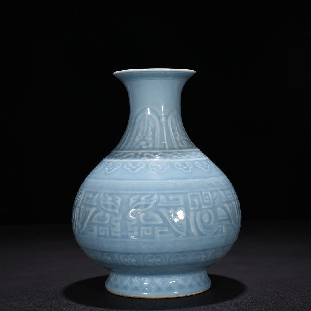 Qing Dynasty Qianlong sky blue glaze carved Taotie pattern jade pot spring vase