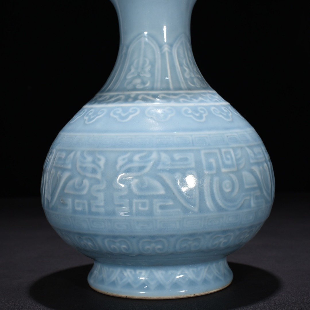 Qing Dynasty Qianlong sky blue glaze carved Taotie pattern jade pot spring vase