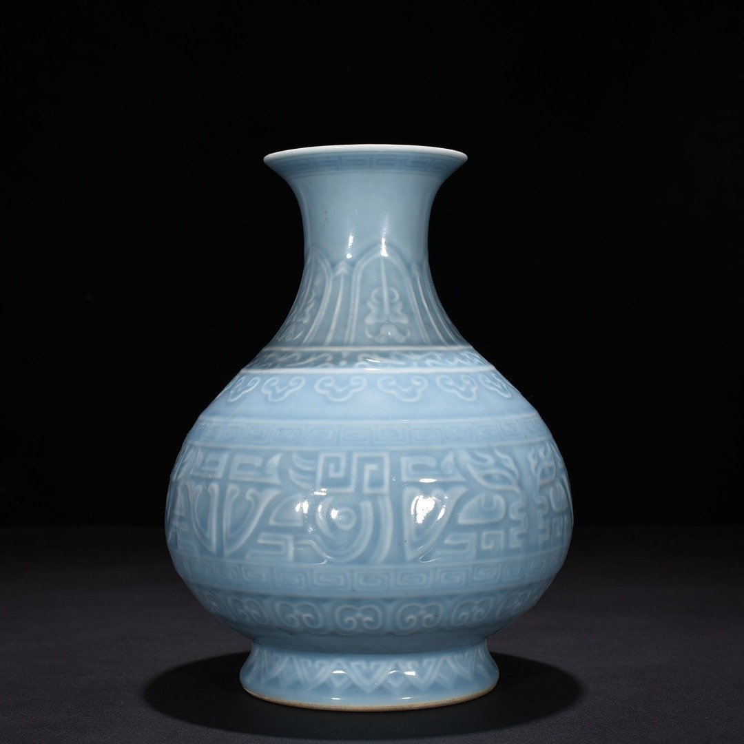 Qing Dynasty Qianlong sky blue glaze carved Taotie pattern jade pot spring vase