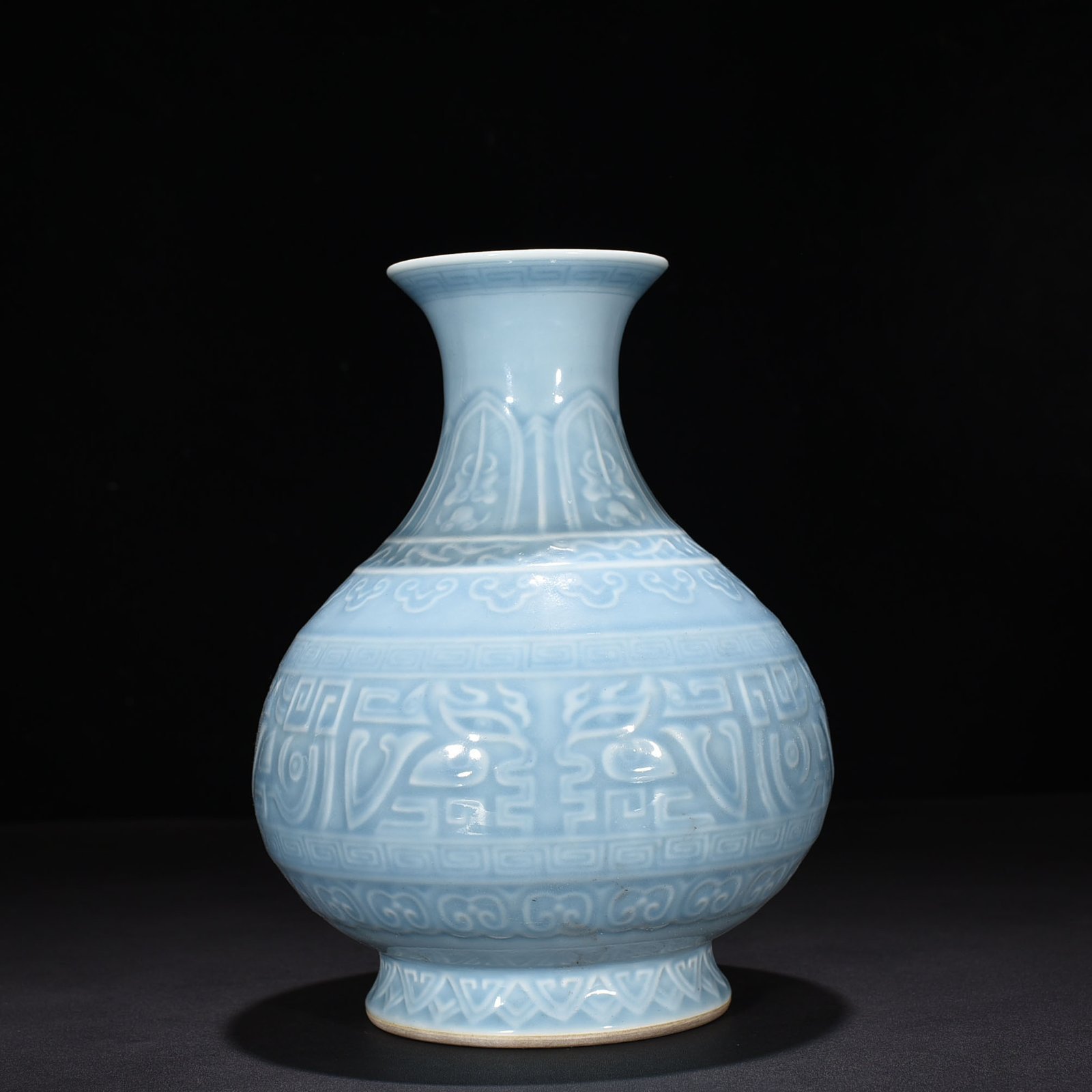 Qing Dynasty Qianlong sky blue glaze carved Taotie pattern jade pot spring vase