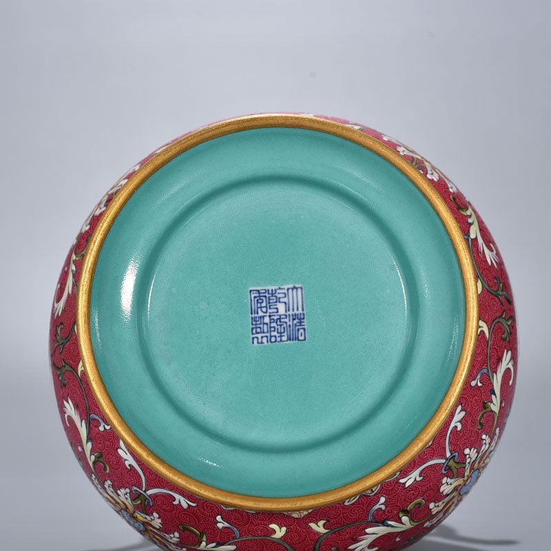 Qing Dynasty Qianlong enamel carmine red rolled four-season flower and bird pattern revolving neck bottle