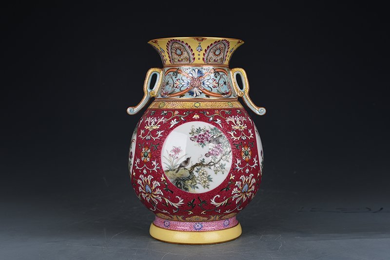 Qing Dynasty Qianlong enamel rouge red rolling pattern consecrated four-season flower and bird neck bottle