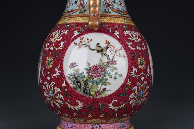 Qing Dynasty Qianlong enamel rouge red rolling pattern consecrated four-season flower and bird neck bottle