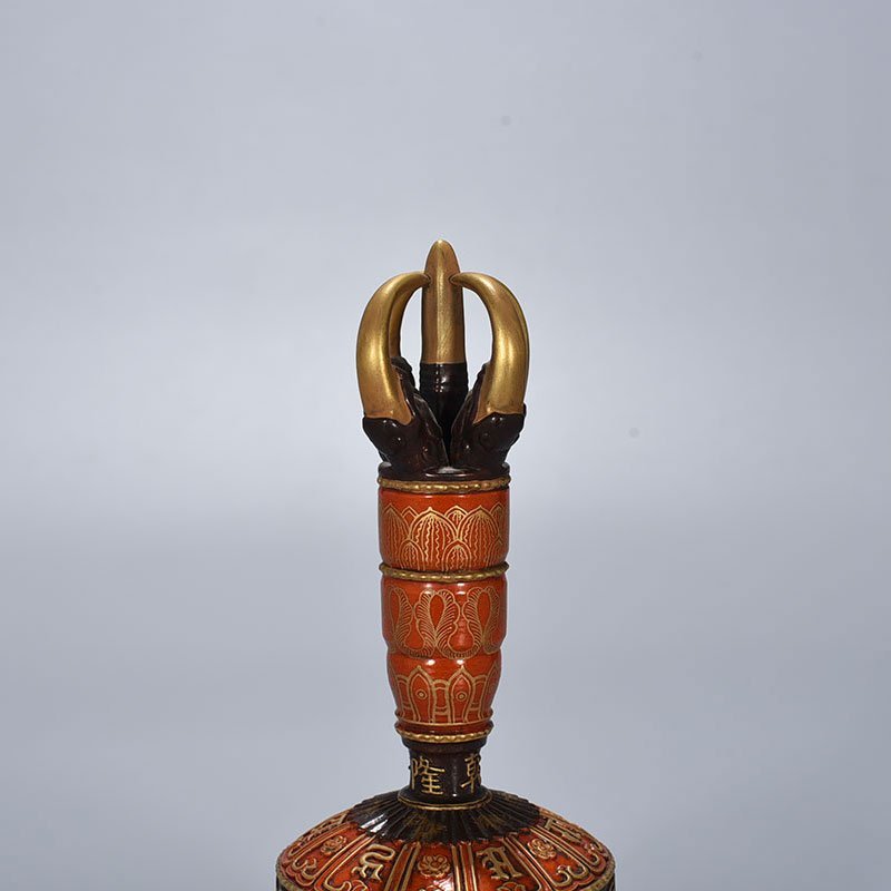 Qing Dynasty Qianlong alum red ground Sanskrit rattles carved with gold on