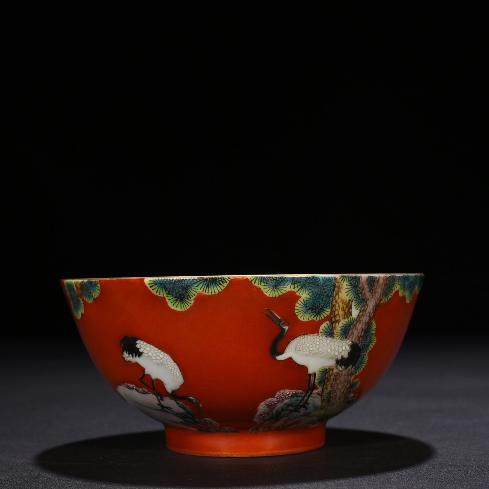 Qing Dynasty Qianlong alum red ground pastel pine and crane longevity pattern bowl