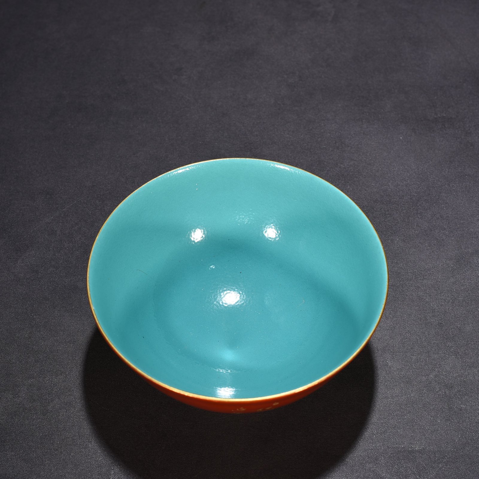 Qing Dynasty Qianlong alum red ground pastel pine and crane longevity pattern bowl