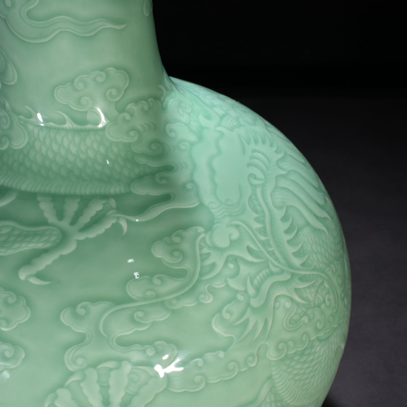 Qing Dynasty Qianlong pink celadon glaze carved cloud and dragon pattern celestial sphere vase