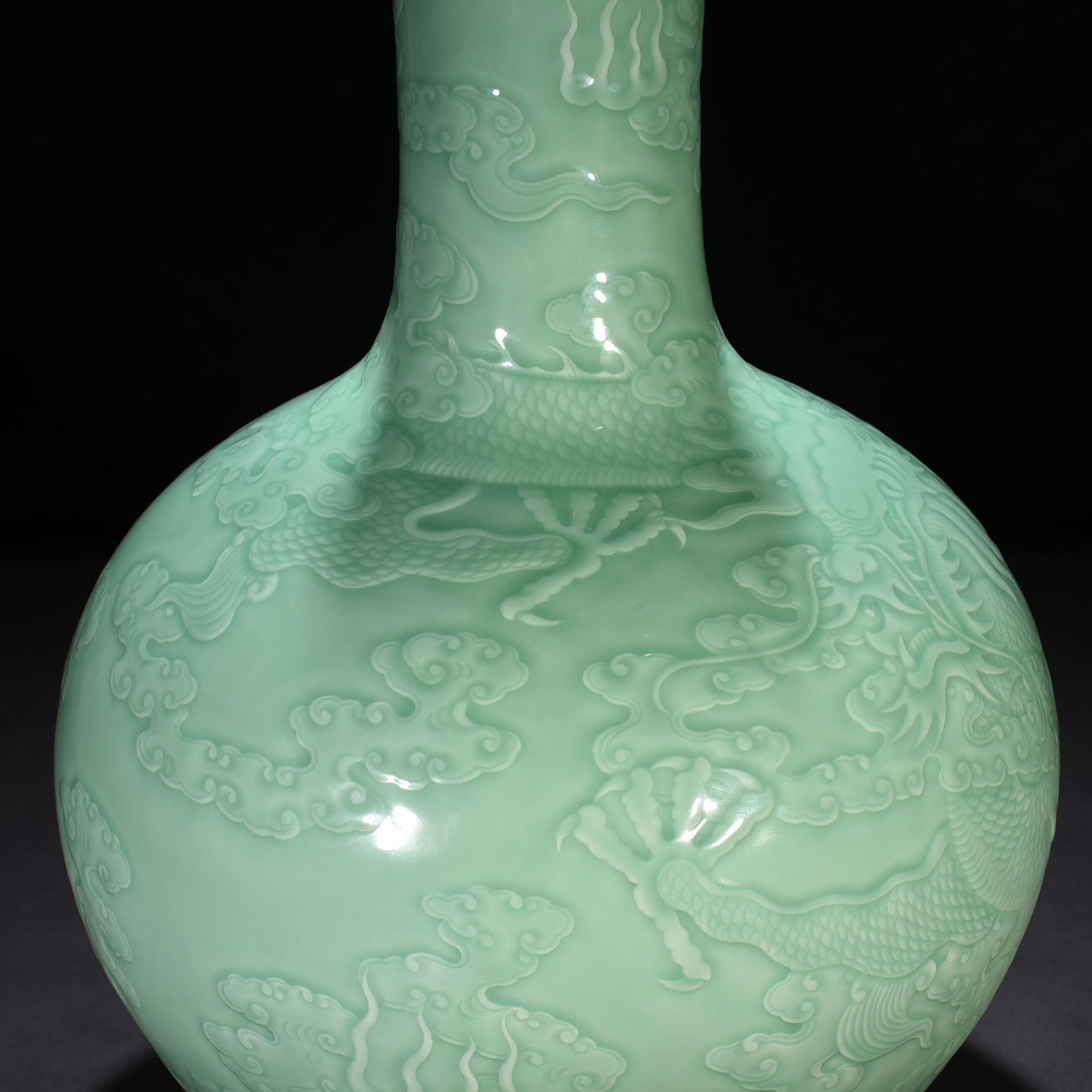 Qing Dynasty Qianlong pink celadon glaze carved cloud and dragon pattern celestial sphere vase