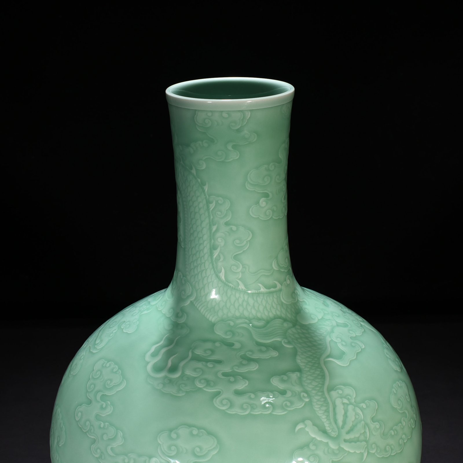 Qing Dynasty Qianlong pink celadon glaze carved cloud and dragon pattern celestial sphere vase
