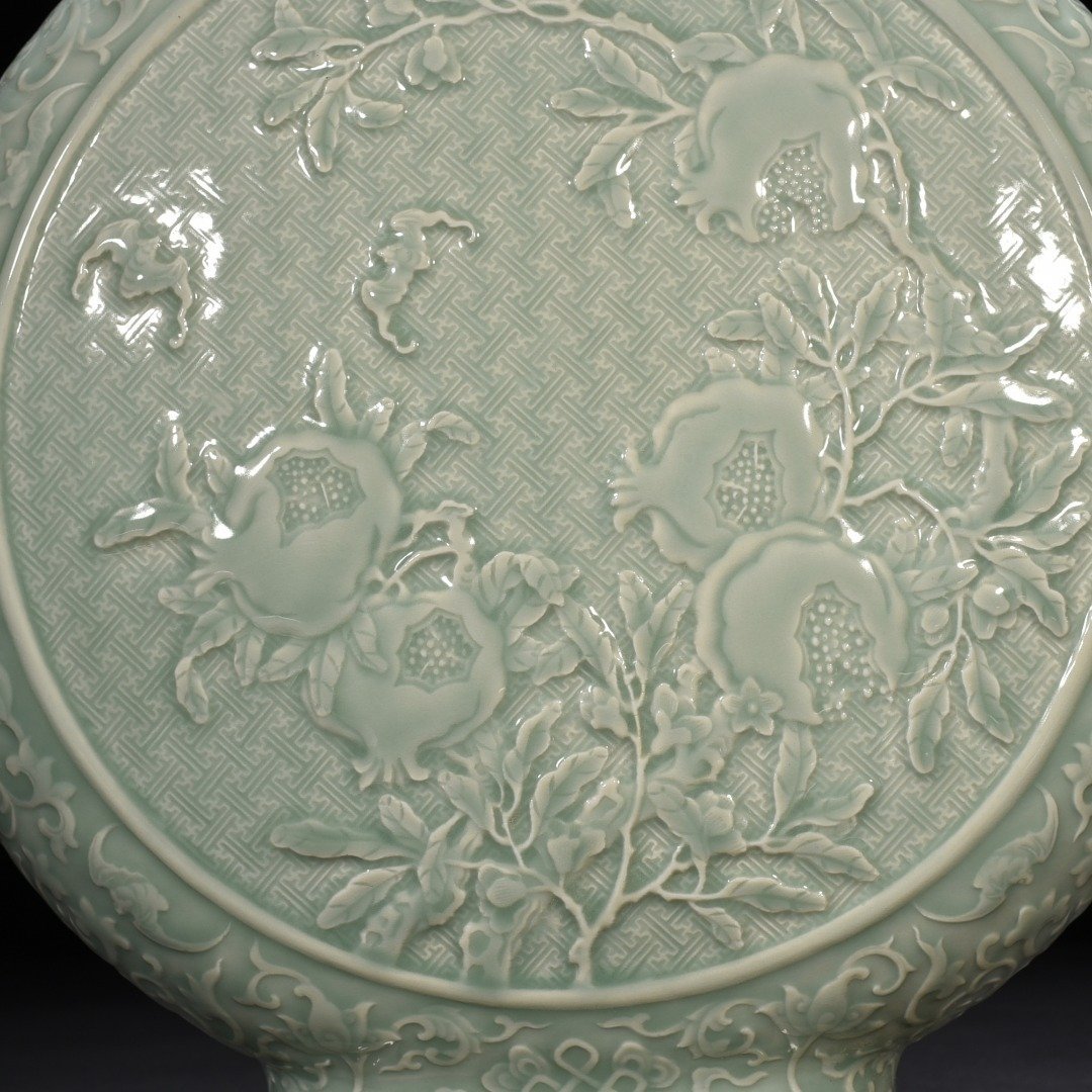Qing Dynasty Qianlong pink celadon glaze carved longevity and multi-child holding moon vas