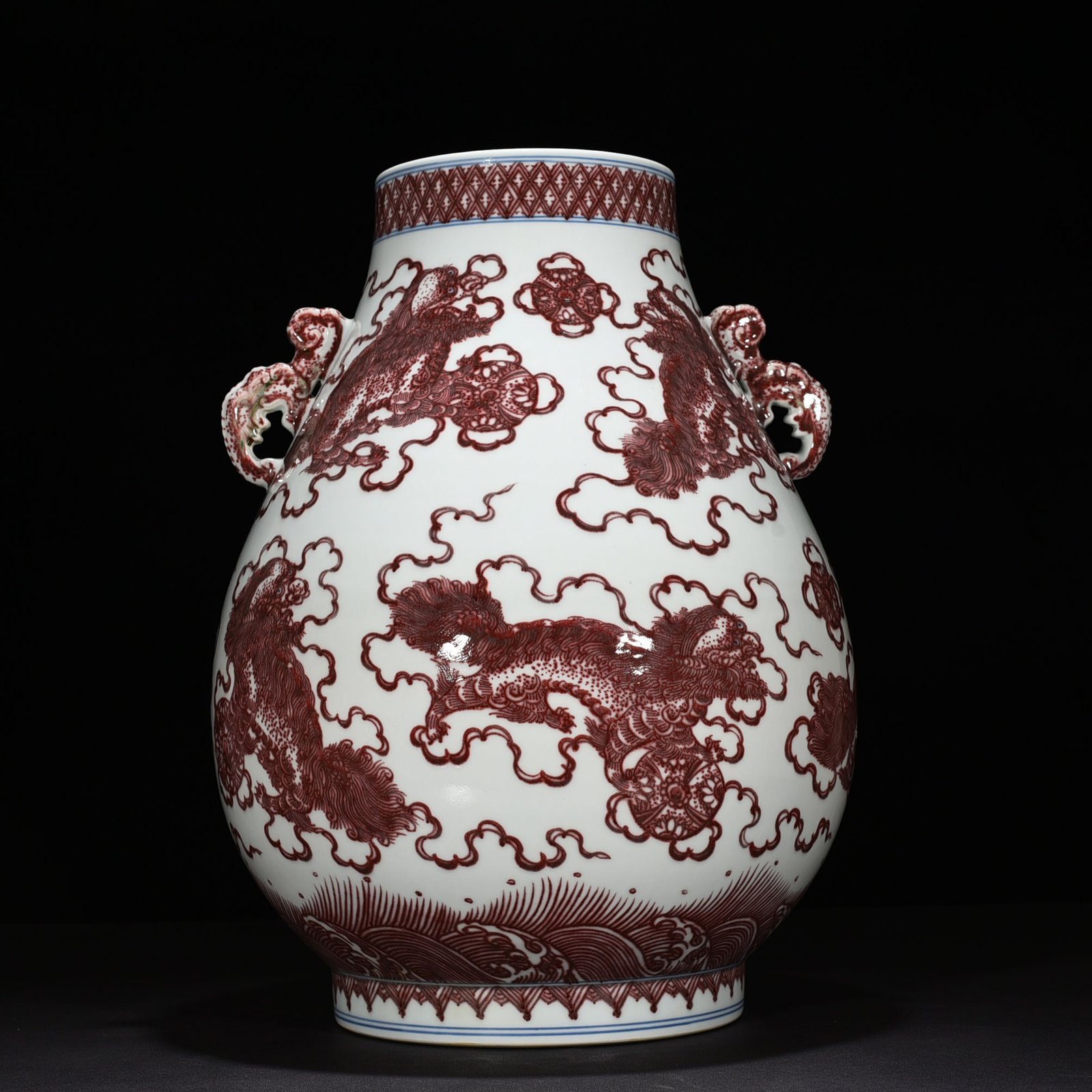 Qing Dynasty Qianlong underglaze red lion rolling hydrangea double-eared statue
