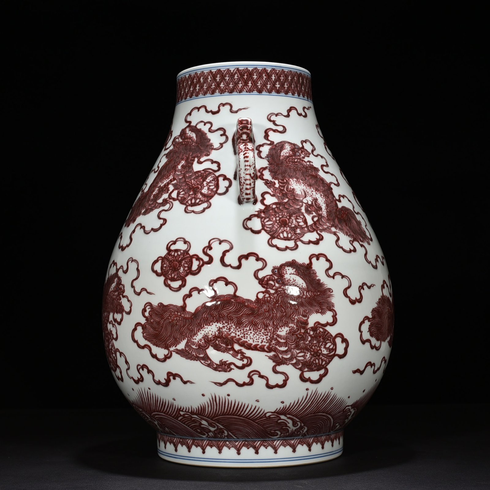 Qing Dynasty Qianlong underglaze red lion rolling hydrangea double-eared statue