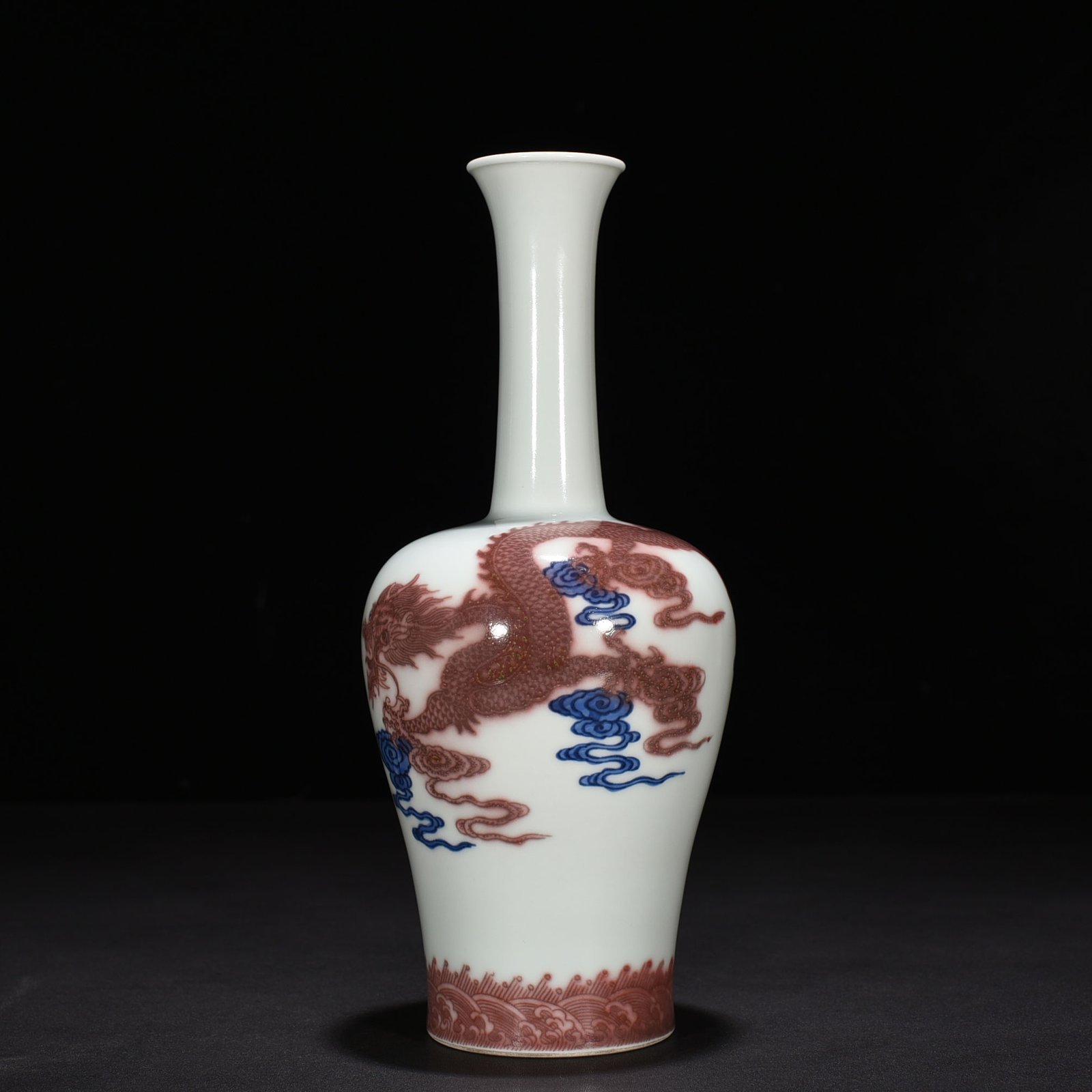 Qing Dynasty Qianlong blue and white underglaze red cloud and dragon pattern rattle vase