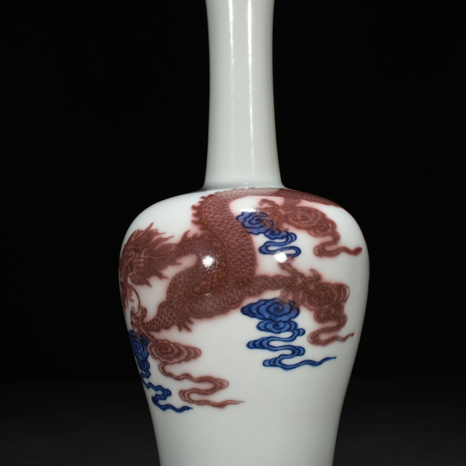 Qing Dynasty Qianlong blue and white underglaze red cloud and dragon pattern rattle vase