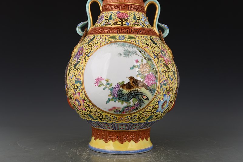 Qing Dynasty Qianlong yellow ground enamel consecrated flower and bird Ruyi ear vase