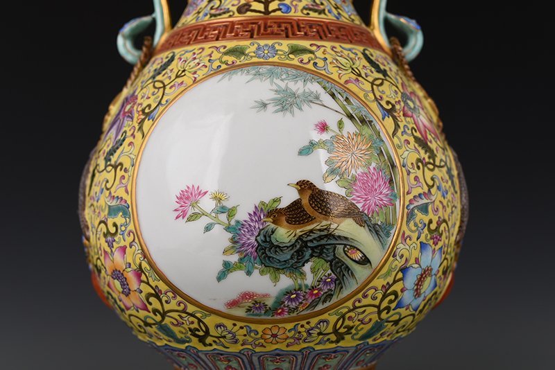 Qing Dynasty Qianlong yellow ground enamel consecrated flower and bird Ruyi ear vase
