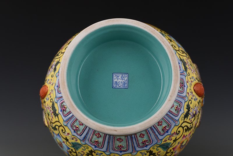 Qing Dynasty Qianlong yellow ground enamel consecrated flower and bird Ruyi ear vase