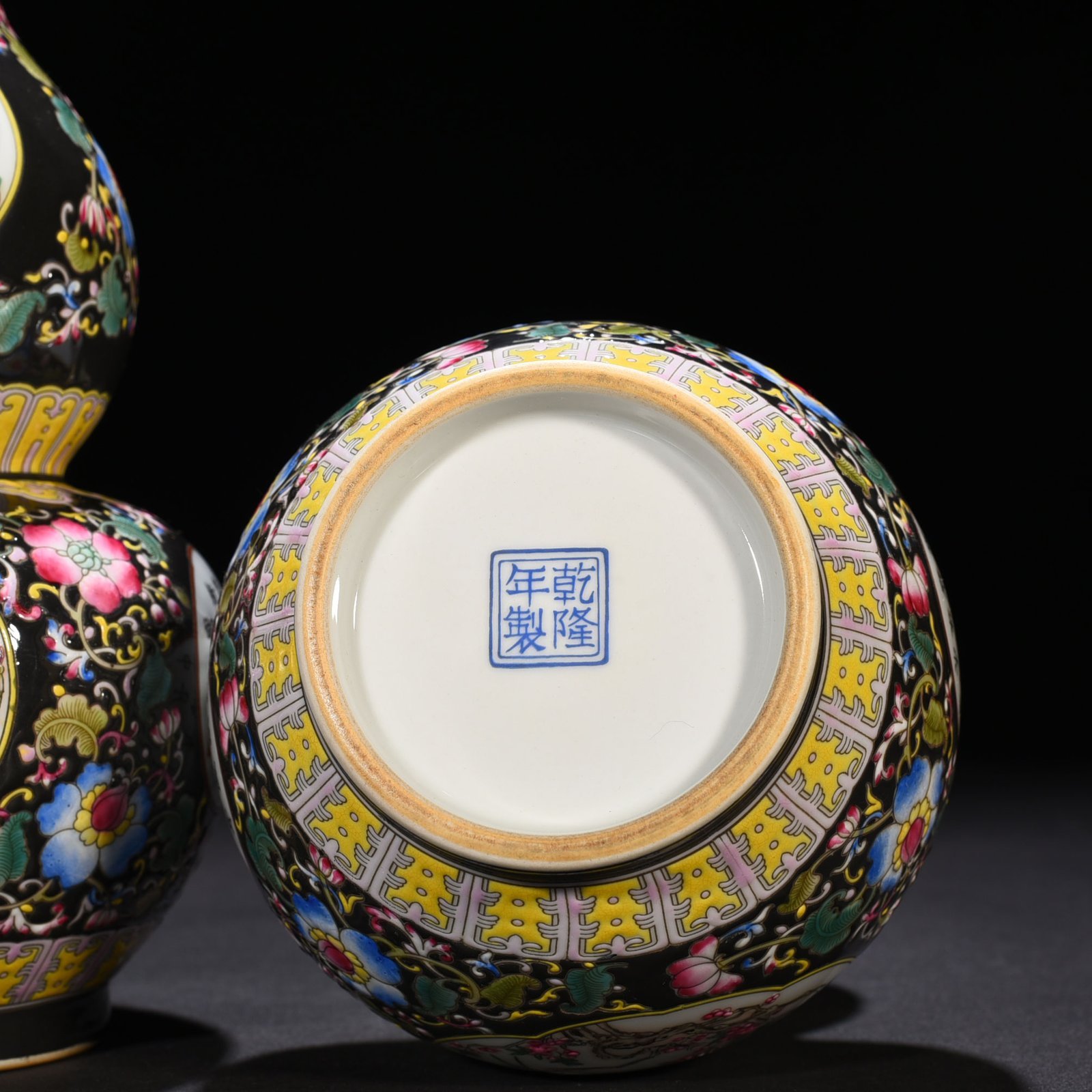 Qing Dynasty Qianlong black ground enamel gourd vase