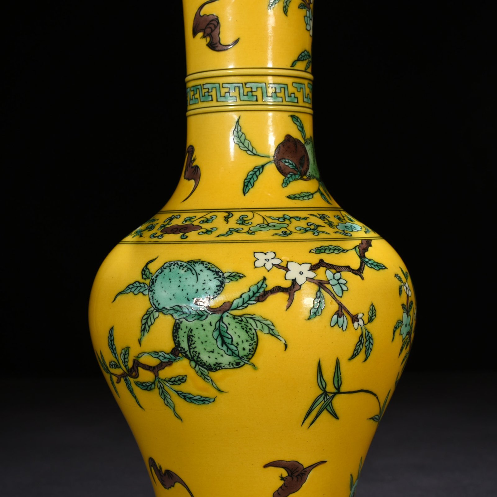 Qing Dynasty Yongzheng yellow ground three-color five-blessing and nine-peach bottle