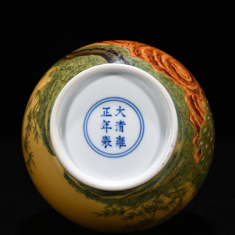 Qing Dynasty Yongzheng yellow glaze pastel peacock flower pattern bile vase