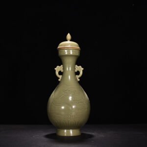 Five Dynasty Yue kiln engraved cloud and dragon pattern double-eared bottle with lid