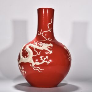 Yuan Dynasty A red glazed celestial sphere vase with cloud and dragon patterns carved