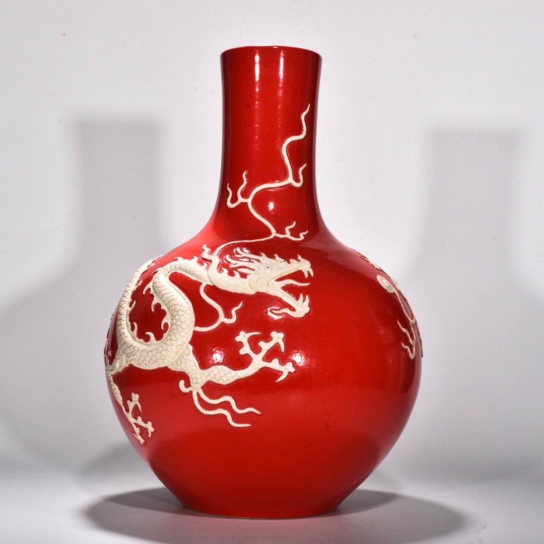 Yuan Dynasty A red glazed celestial sphere vase with cloud and dragon patterns carved