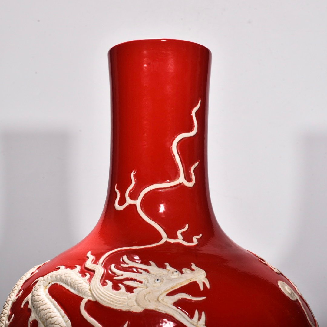 Yuan Dynasty A red glazed celestial sphere vase with cloud and dragon patterns carved