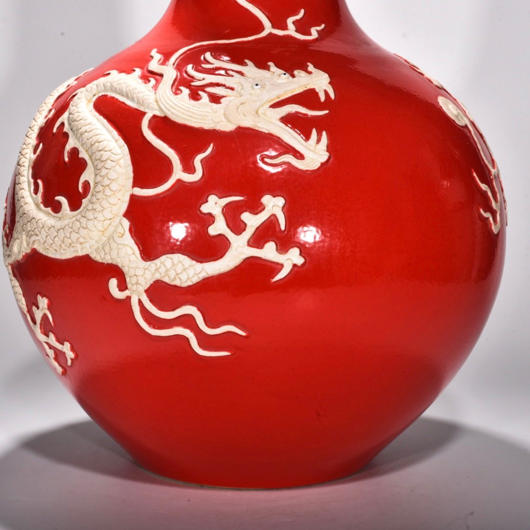 Yuan Dynasty A red glazed celestial sphere vase with cloud and dragon patterns carved
