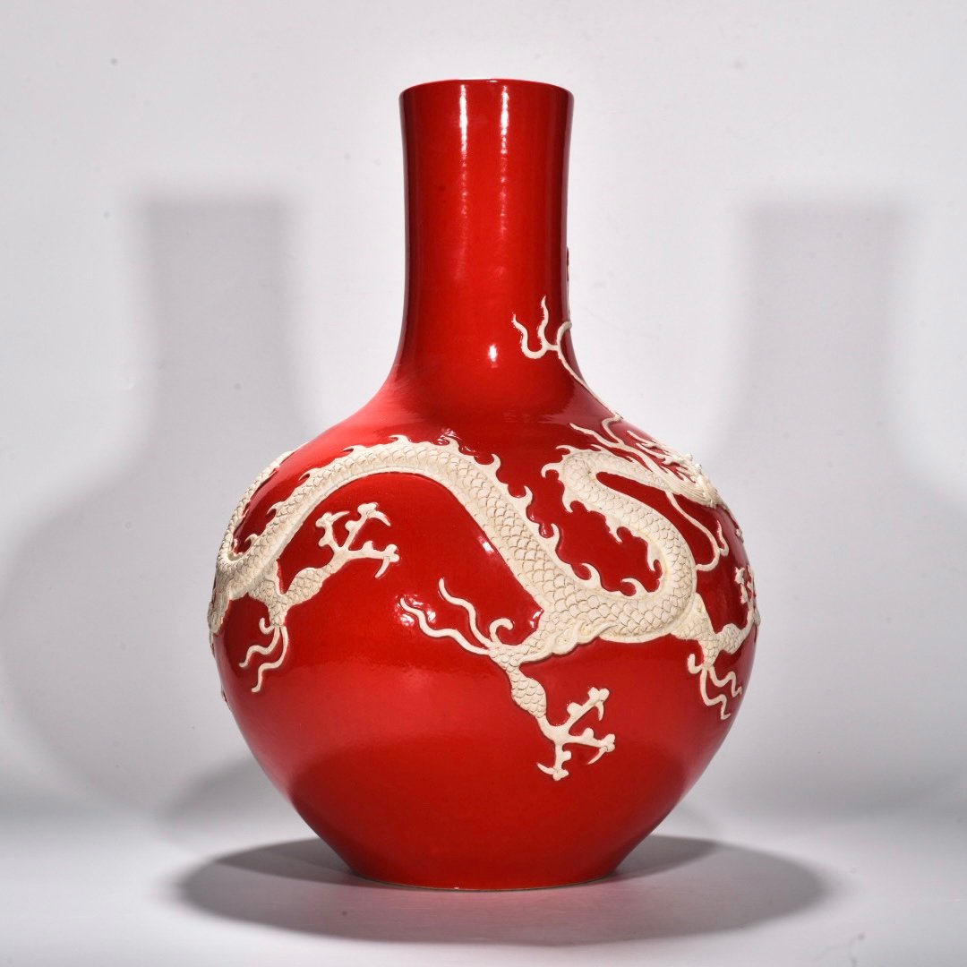 Yuan Dynasty A red glazed celestial sphere vase with cloud and dragon patterns carved