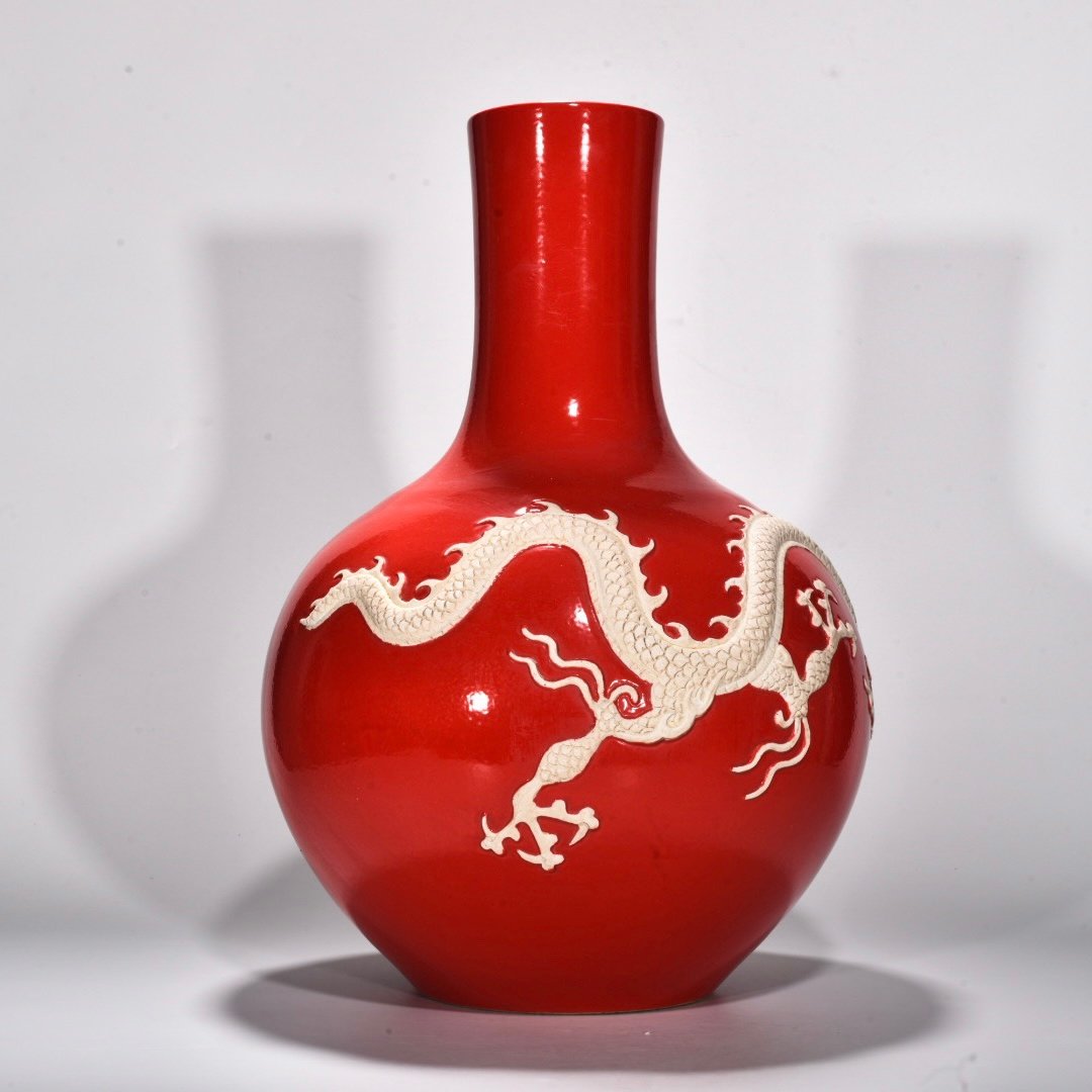 Yuan Dynasty A red glazed celestial sphere vase with cloud and dragon patterns carved
