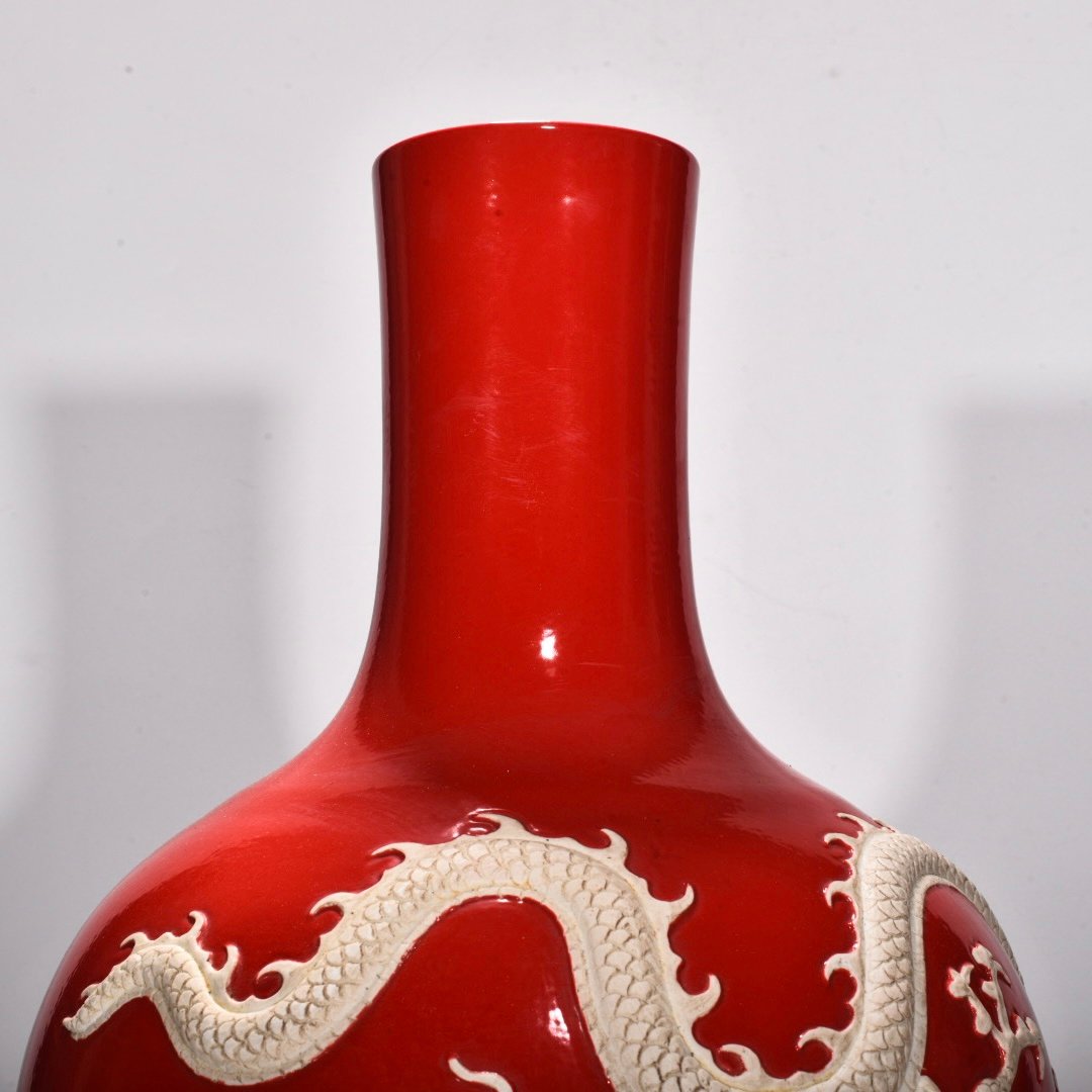 Yuan Dynasty A red glazed celestial sphere vase with cloud and dragon patterns carved