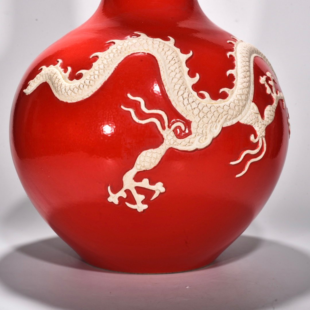 Yuan Dynasty A red glazed celestial sphere vase with cloud and dragon patterns carved