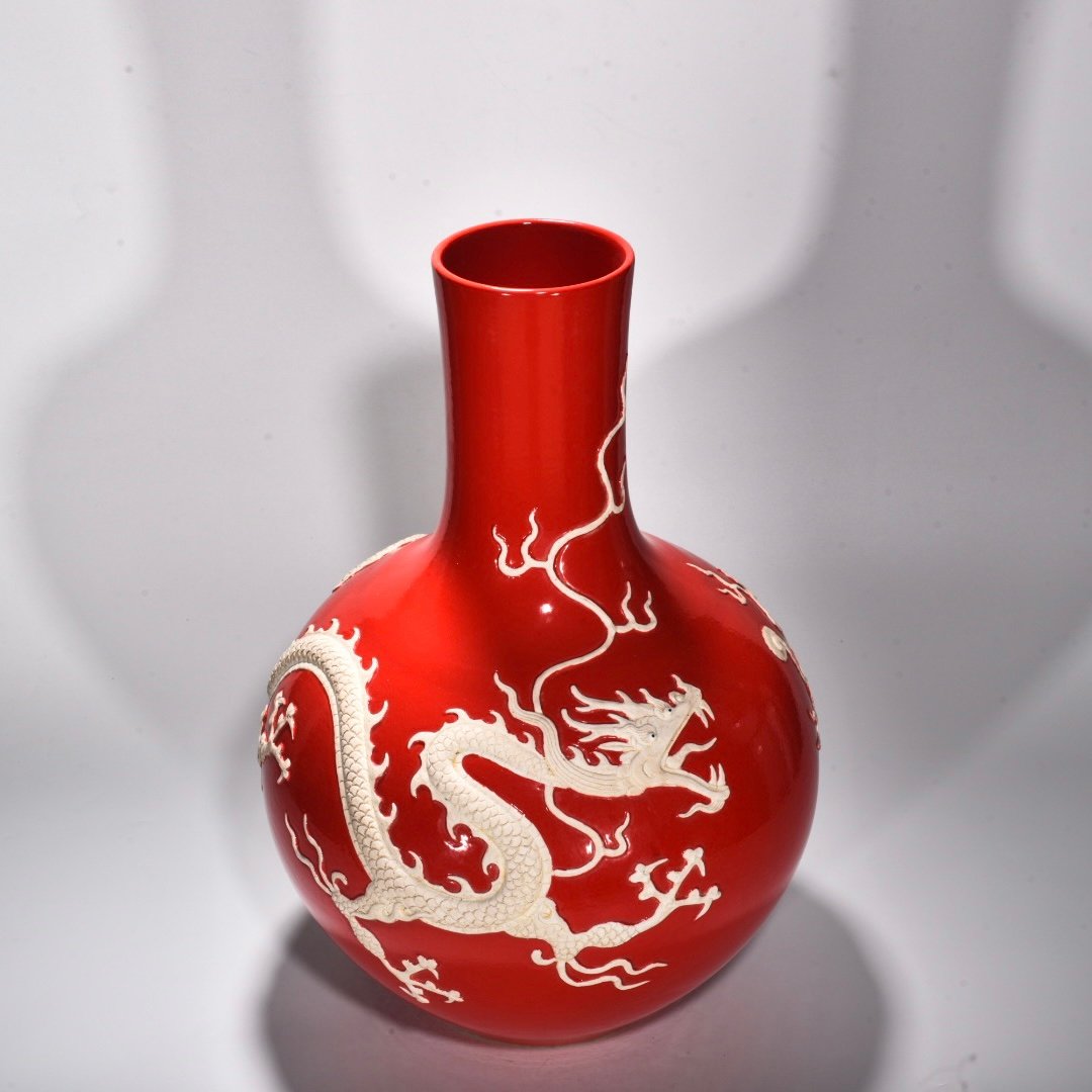Yuan Dynasty A red glazed celestial sphere vase with cloud and dragon patterns carved