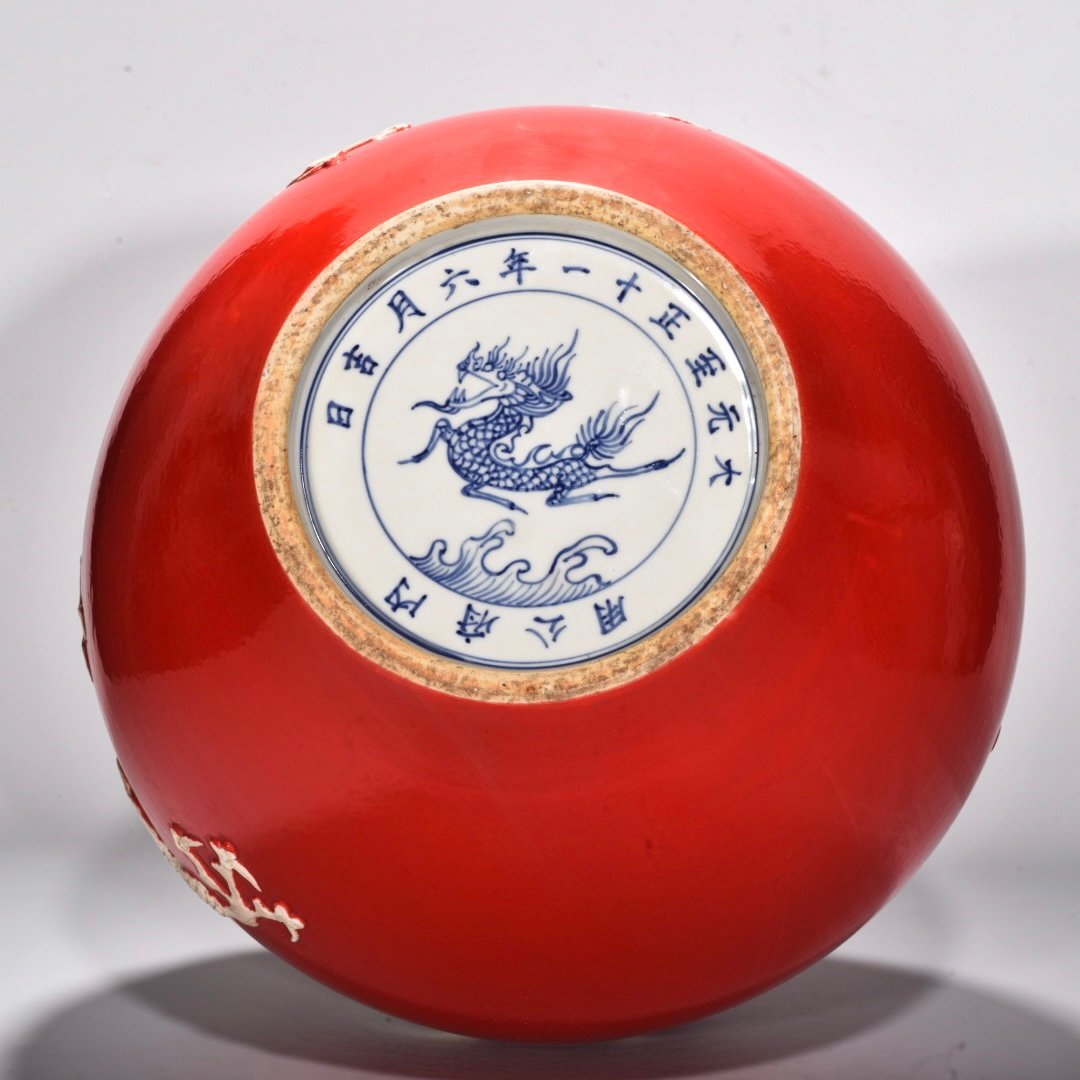 Yuan Dynasty A red glazed celestial sphere vase with cloud and dragon patterns carved