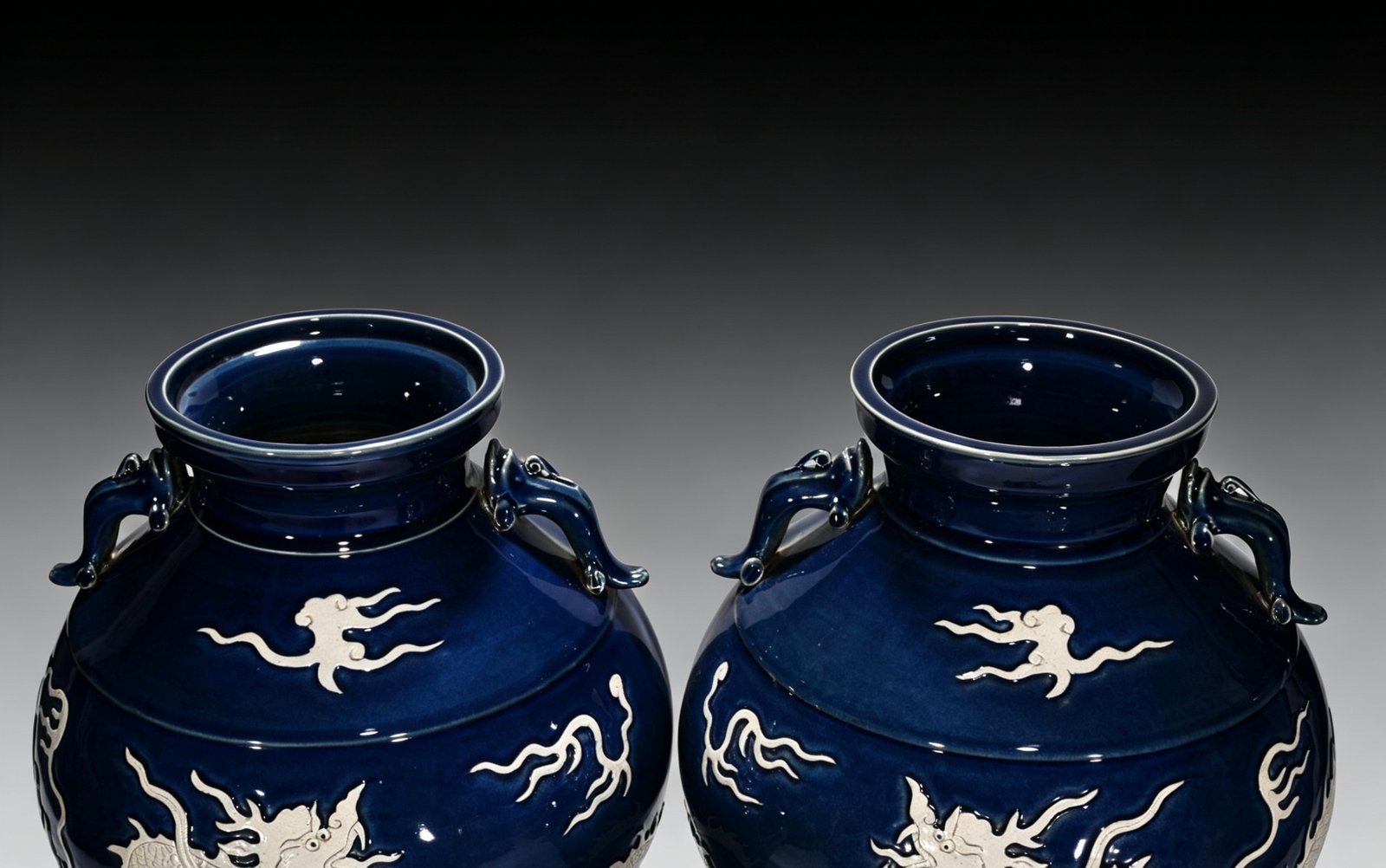 Yuan Dynasty blue glaze with white space and engraved cloud and dragon pattern on the ear jar