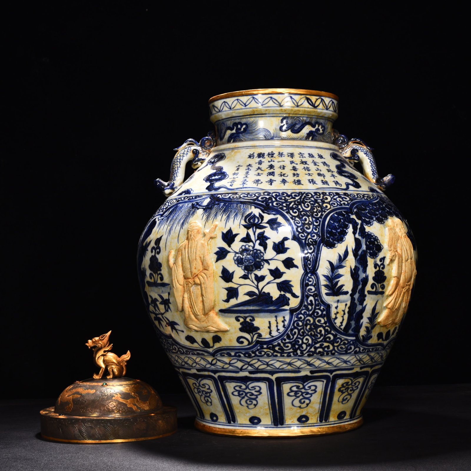 Yuan Dynasty blue and white carved Eight Immortals pattern with ear lid jar