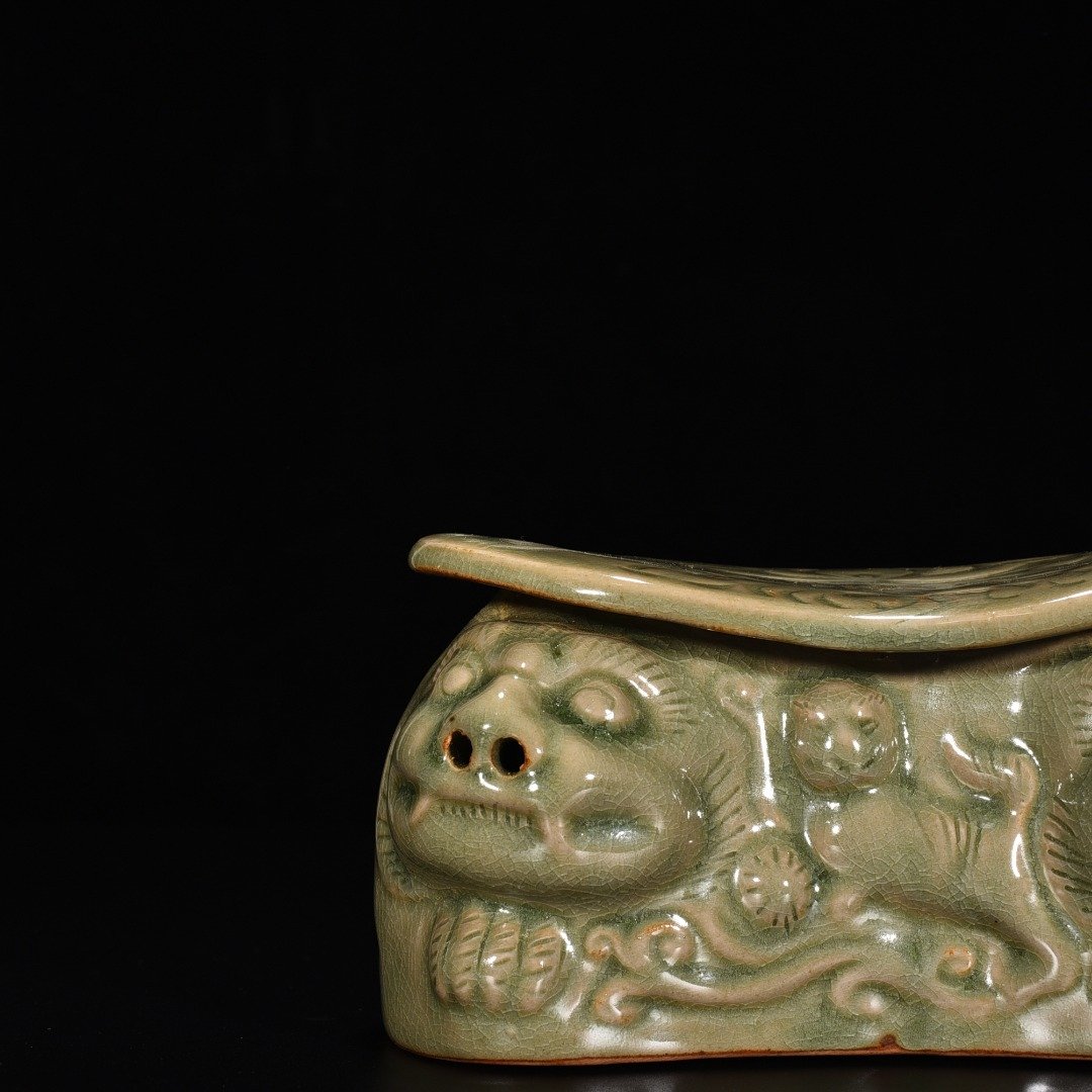 Song Dynasty Yaozhou kiln celadon lion pillow with carved flower pattern