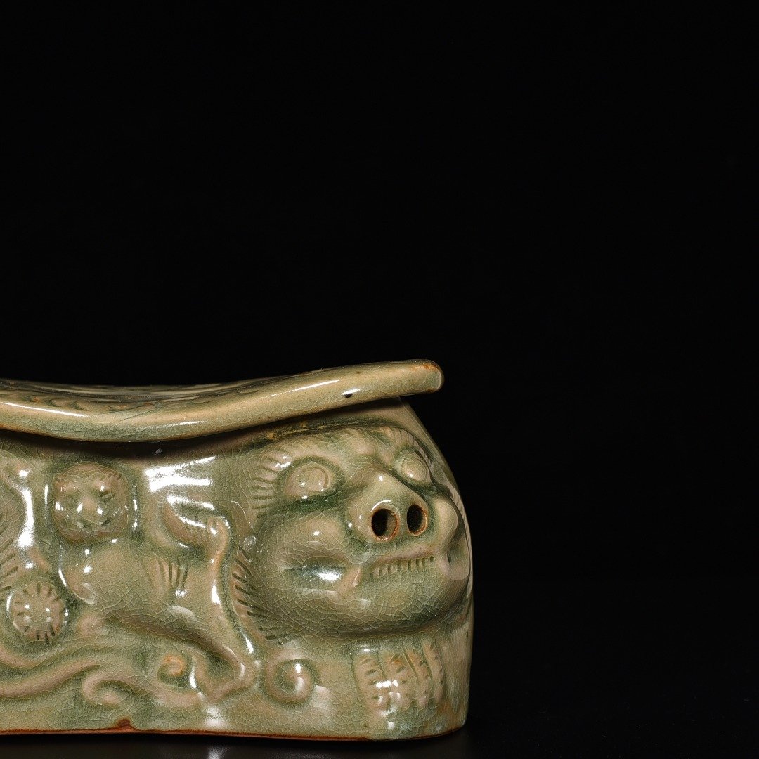 Song Dynasty Yaozhou kiln celadon lion pillow with carved flower pattern