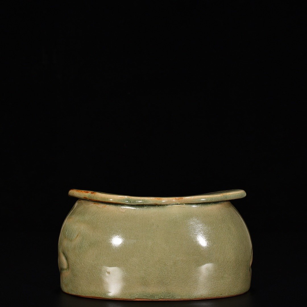 Song Dynasty Yaozhou kiln celadon lion pillow with carved flower pattern