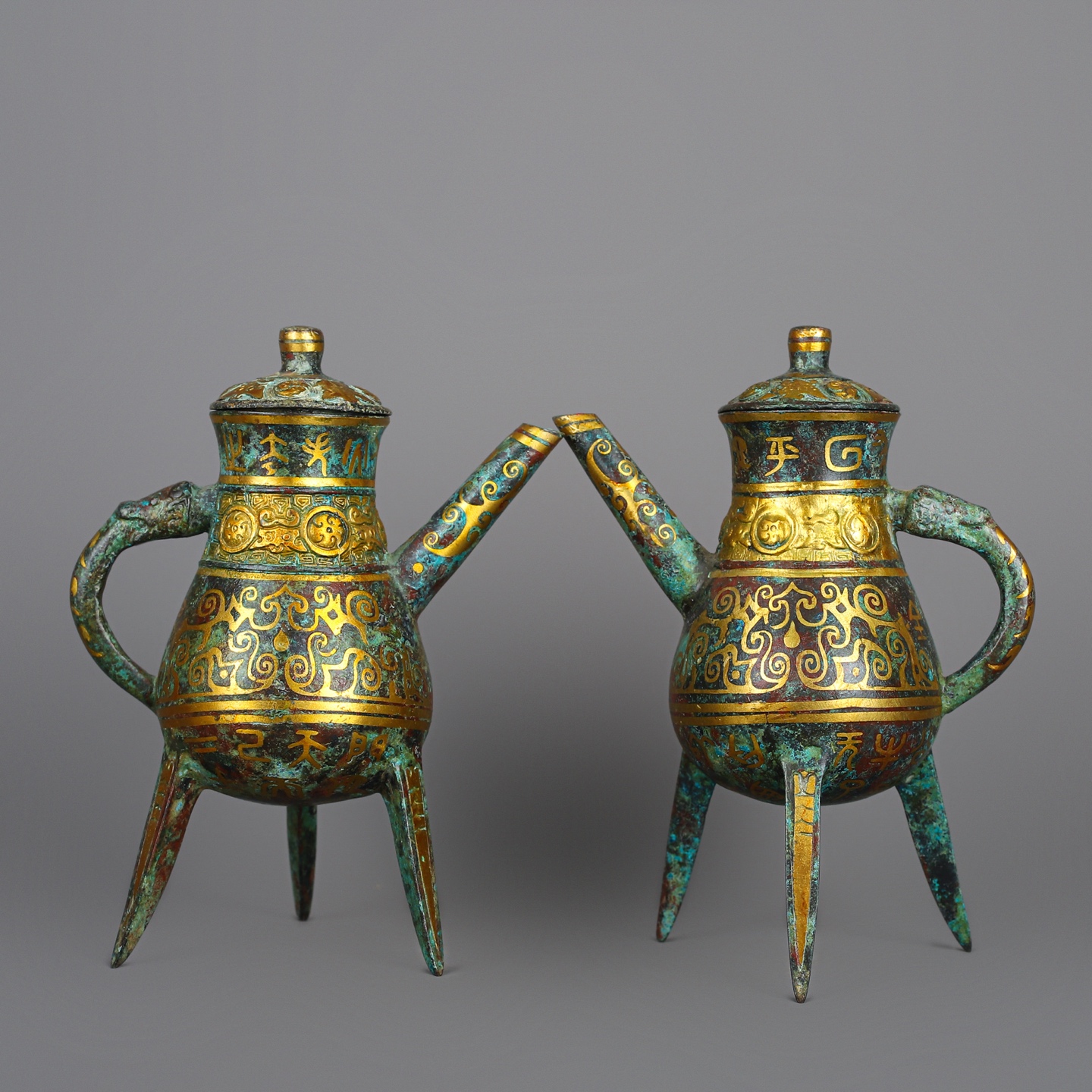 Han Dynasty Pair of bronze and gold three legged wine bottles